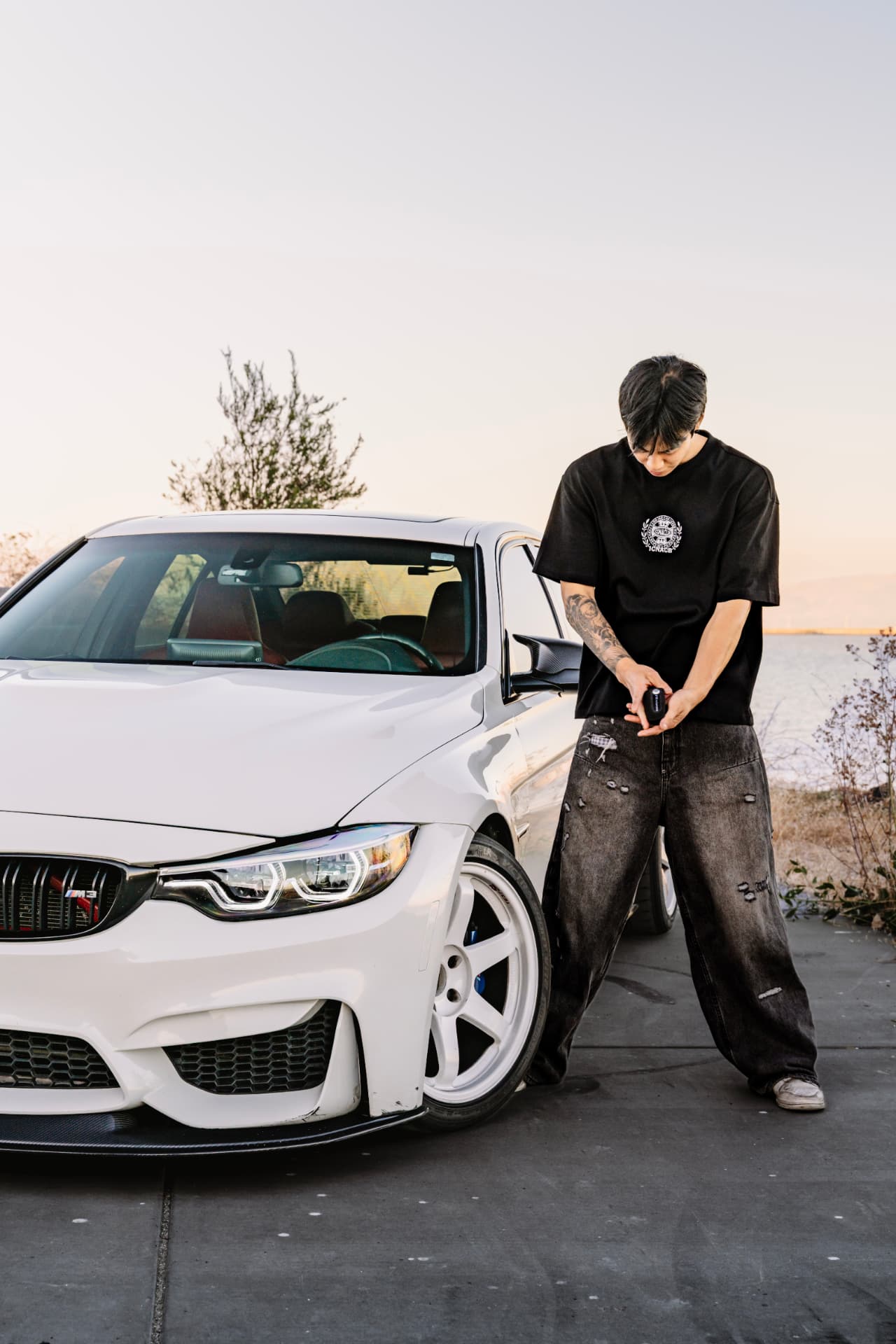 Owner with the key beside the BMW M3 F80 front end