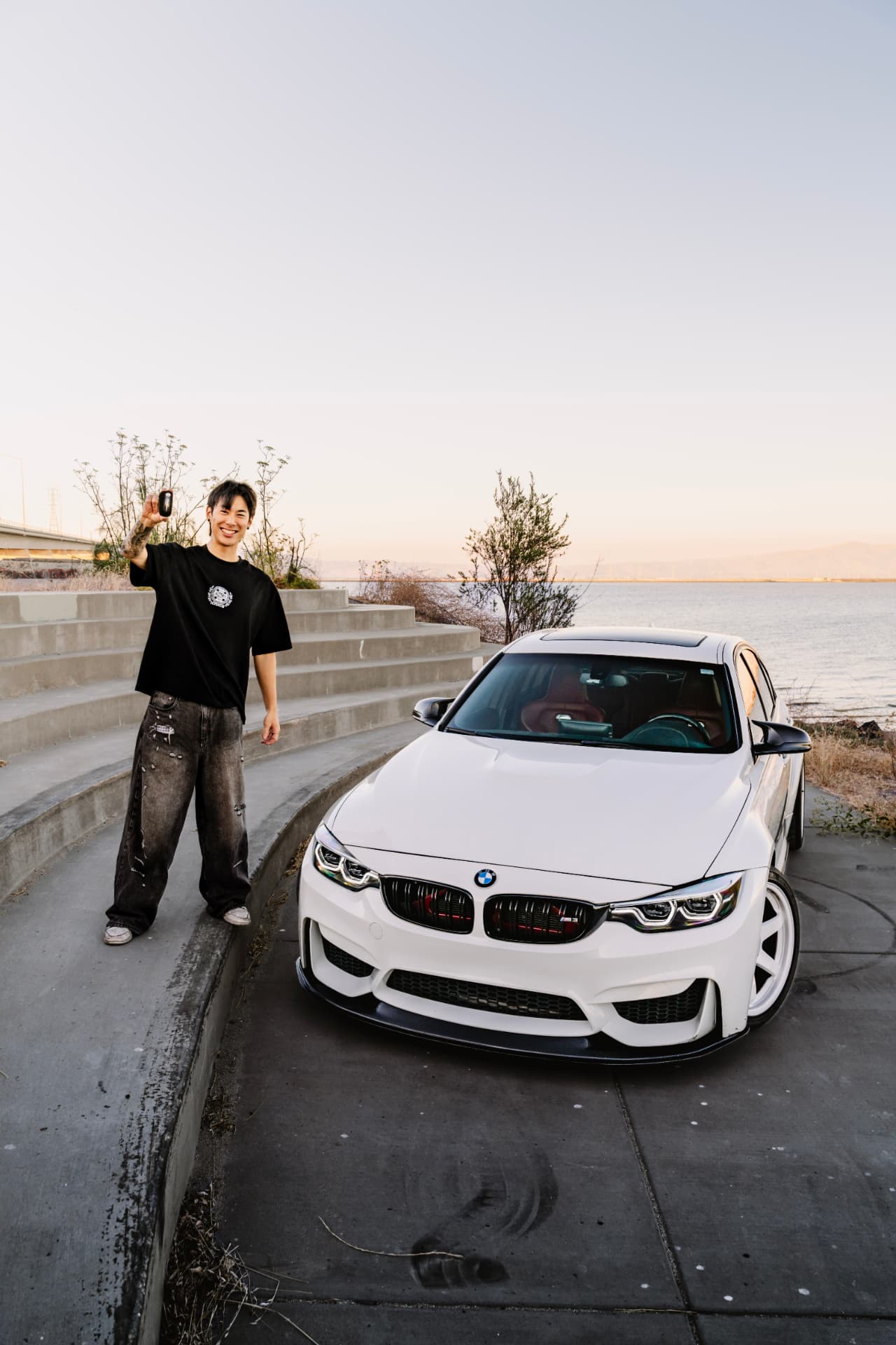 Owner holding the key next to the BMW M3 F80