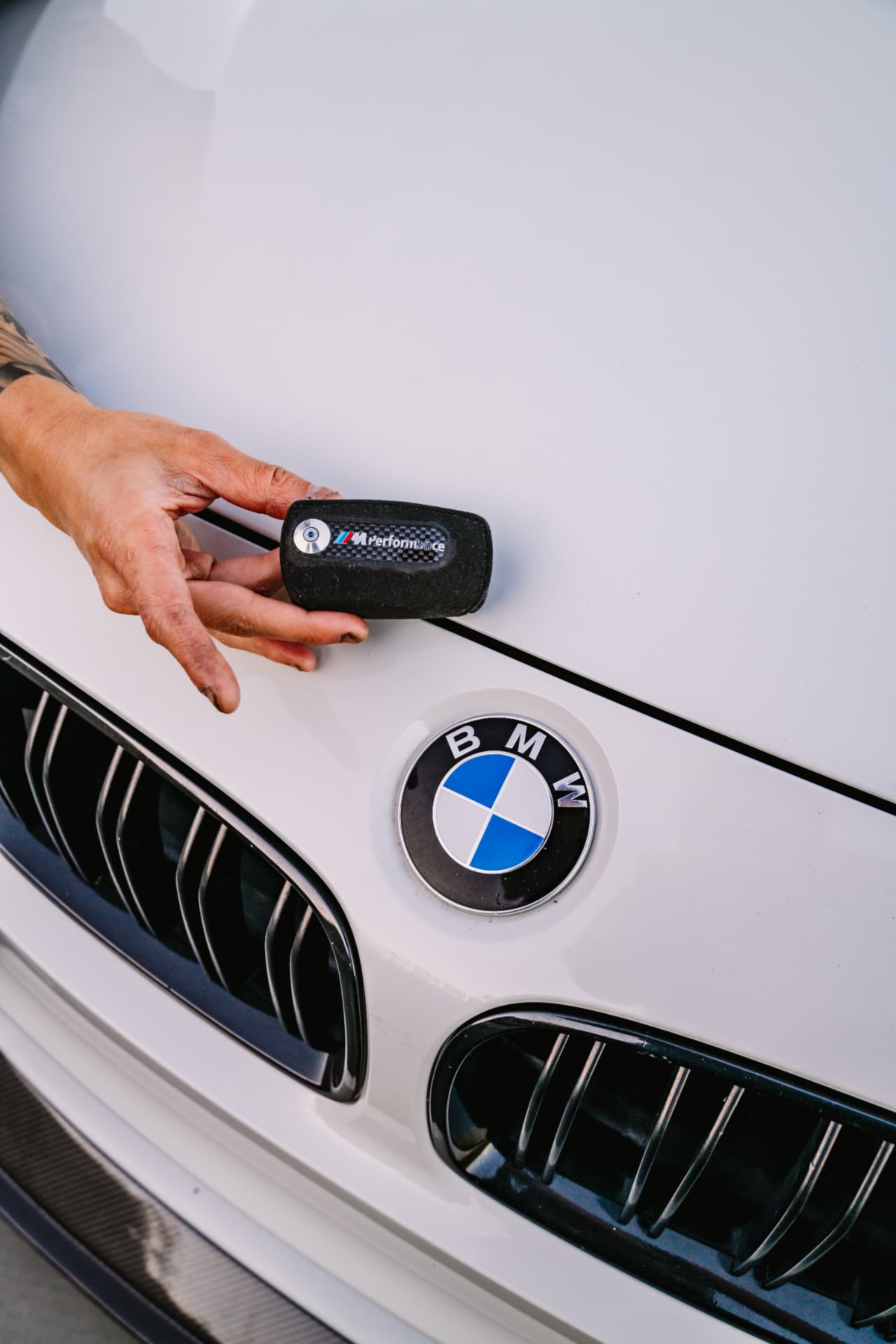 M Performance key fob resting on the BMW M3 F80 hood