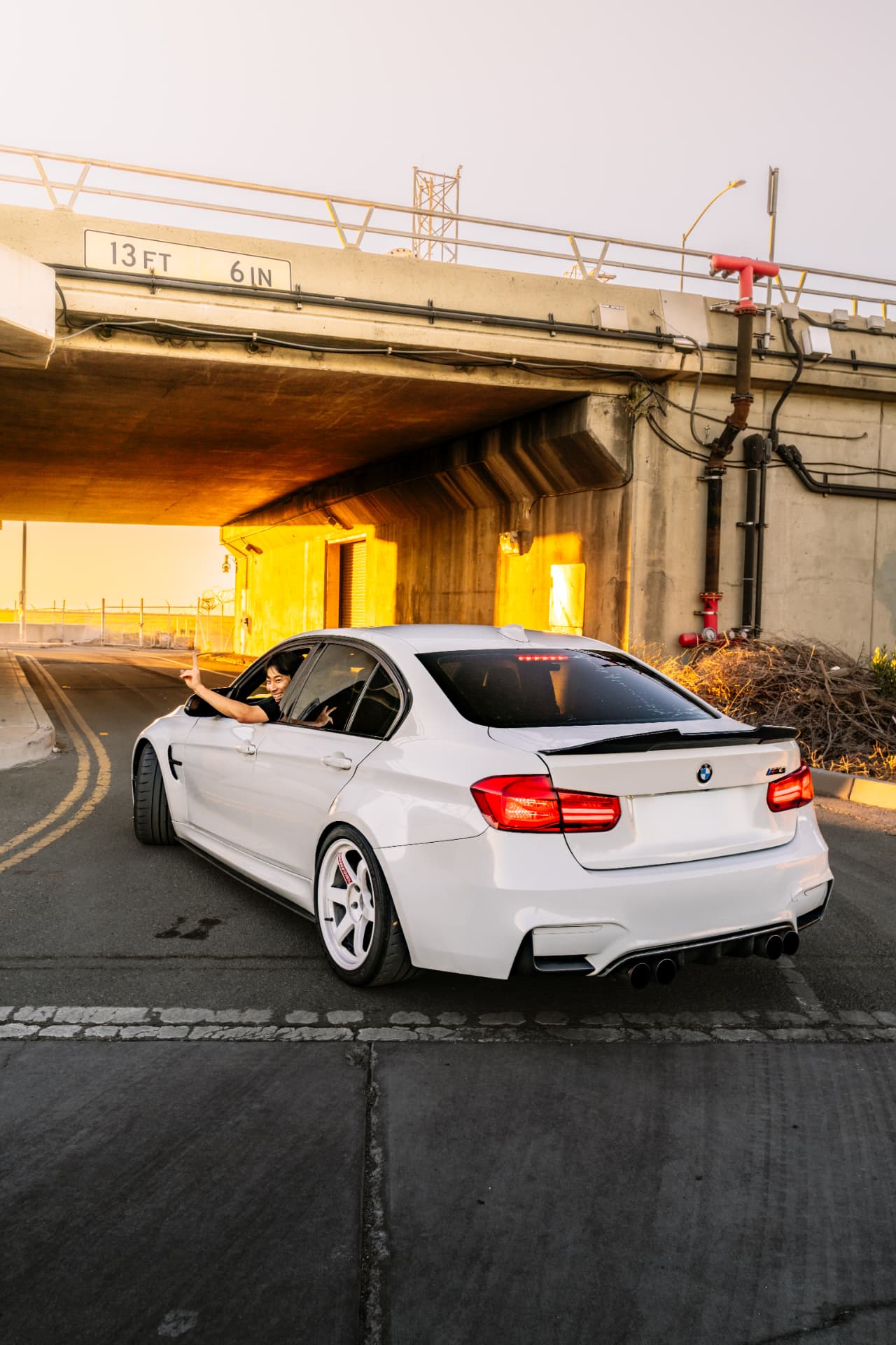 BMW M3 F80 rear three-quarter under the overpass