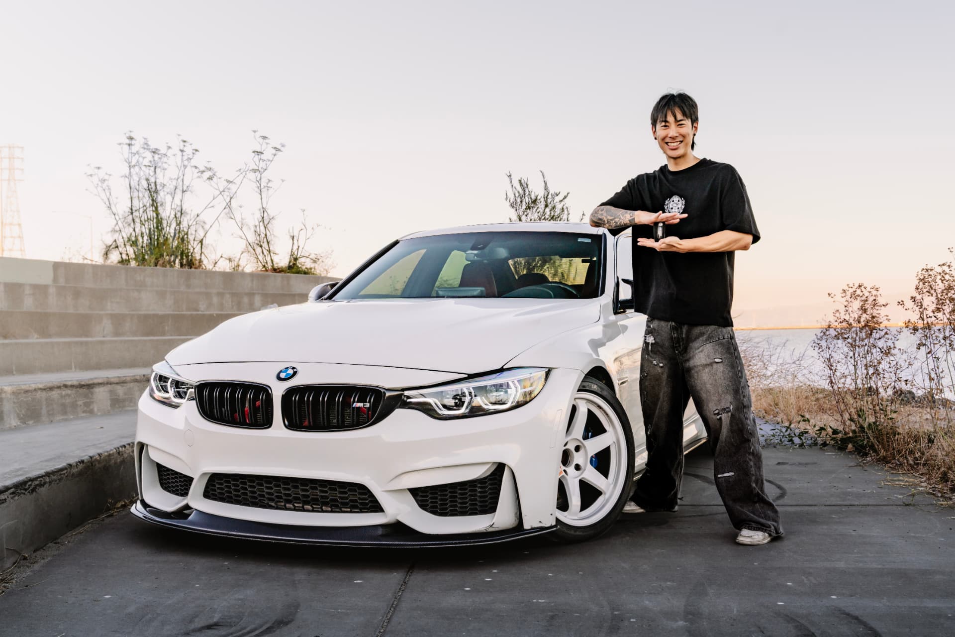 Owner presenting the key beside the BMW M3 F80